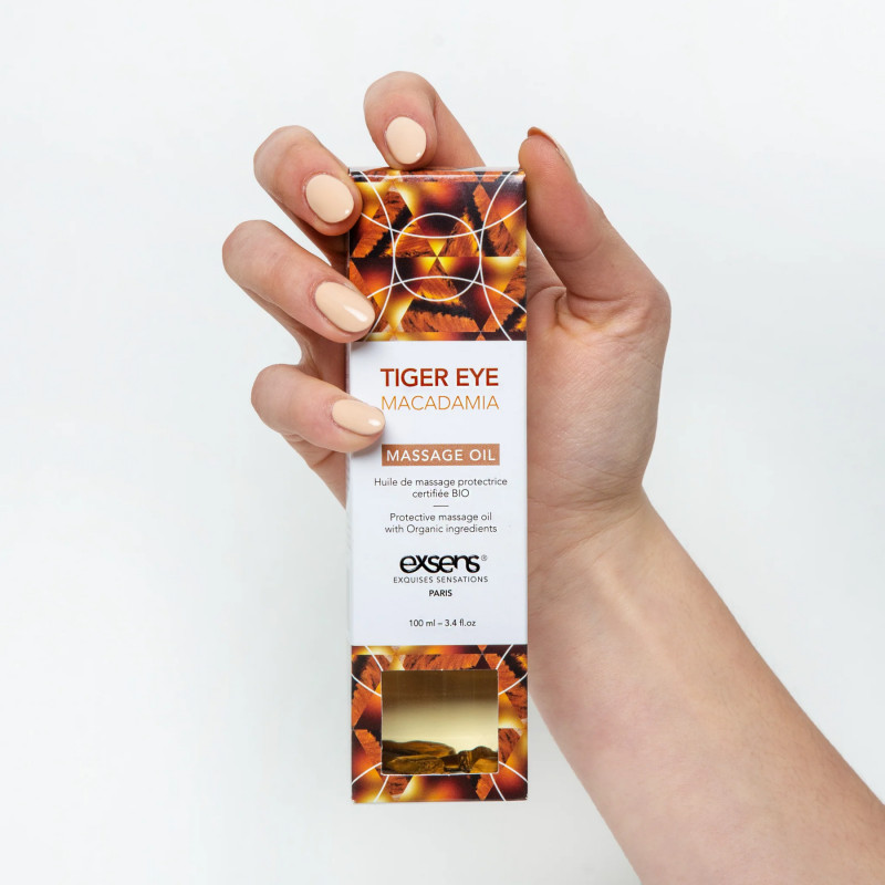 Упаковка масажної олії Exsens Tiger Eye Macadamia, що підкреслює її преміальну якість