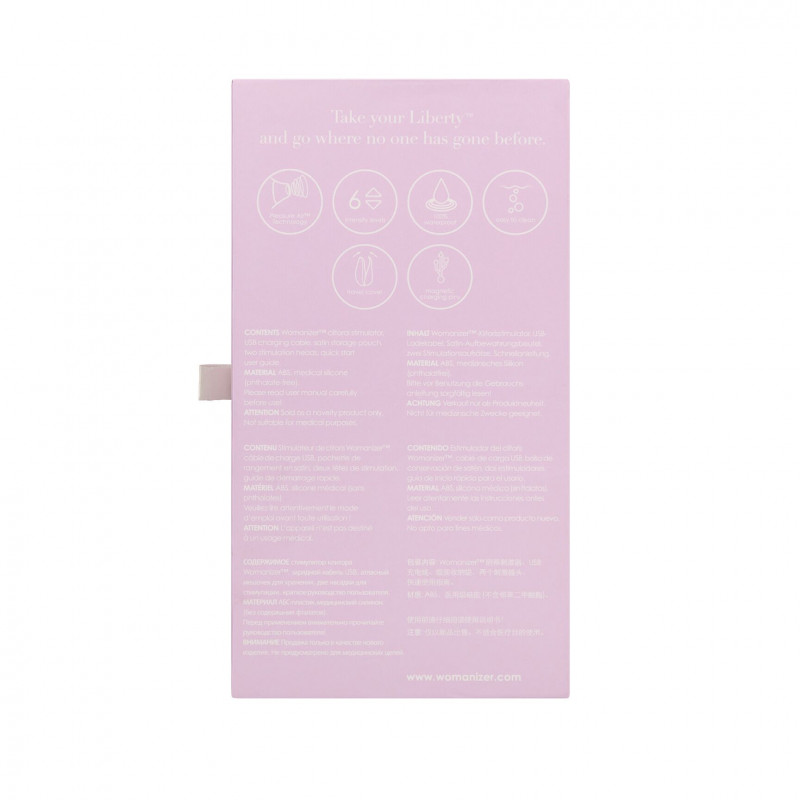 Повна комплектація вакуумного кліторального стимулятора Womanizer Liberty Lilac: пристрій, дві насадки, магнітна кришка та інструкція.